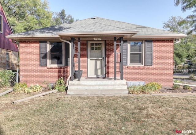 bungalow-style home with a front lawn