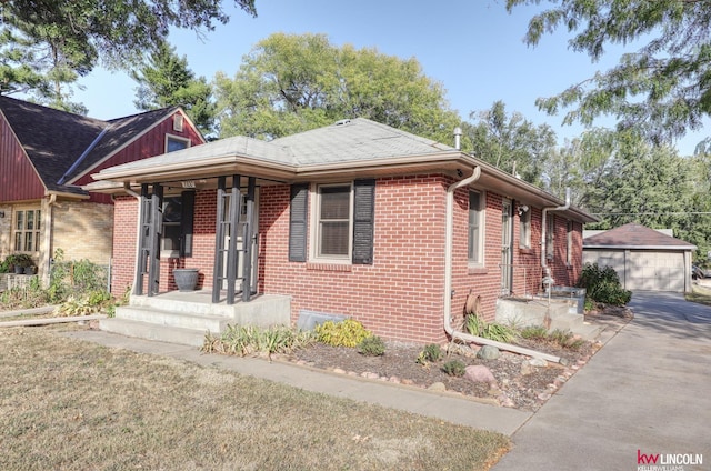 view of front facade featuring a garage and an outdoor structure