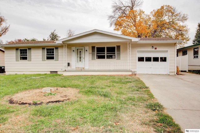 single story home with covered porch, a front yard, and a garage