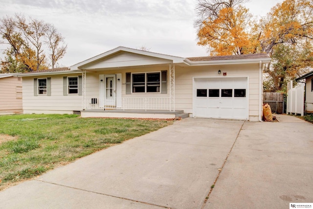 ranch-style house with covered porch, a garage, and a front lawn