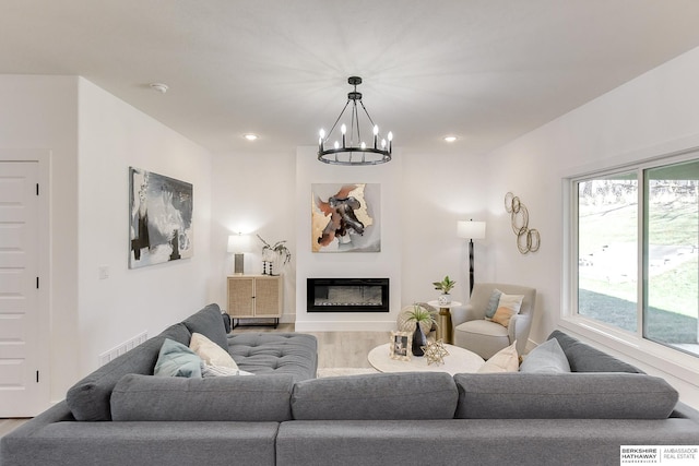 living room with hardwood / wood-style floors and a notable chandelier