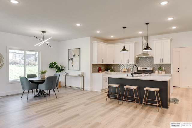 kitchen featuring white cabinetry, sink, and light hardwood / wood-style flooring