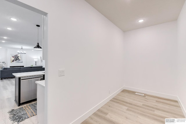 corridor with light hardwood / wood-style floors