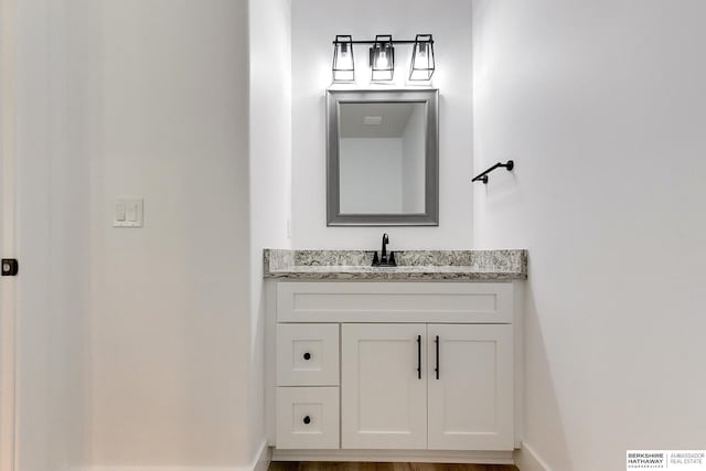 bathroom with vanity and wood-type flooring