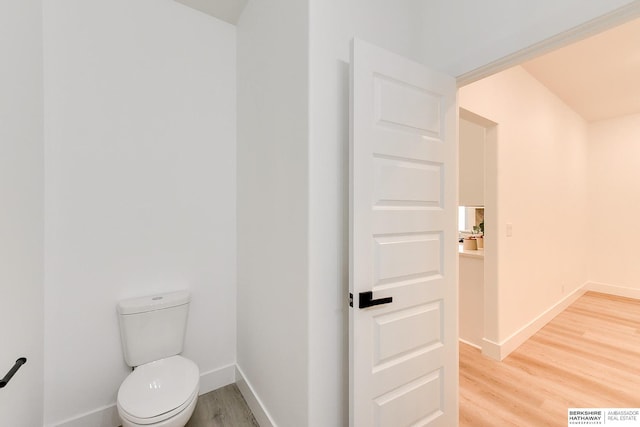 bathroom with toilet and wood-type flooring