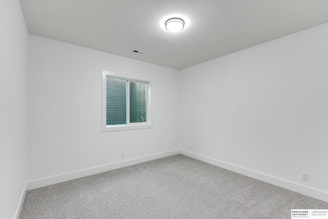 unfurnished room featuring carpet flooring