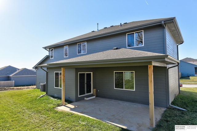 rear view of house featuring central air condition unit, a yard, and a patio