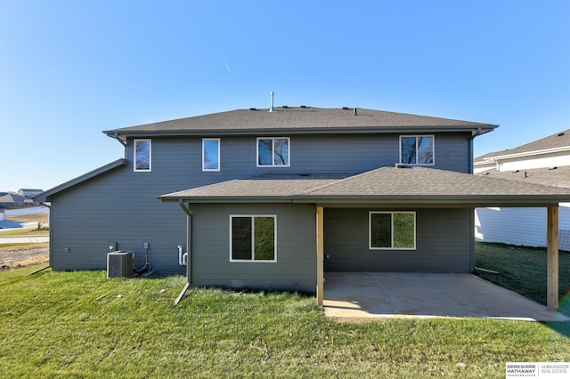 back of house with a patio, central air condition unit, and a lawn