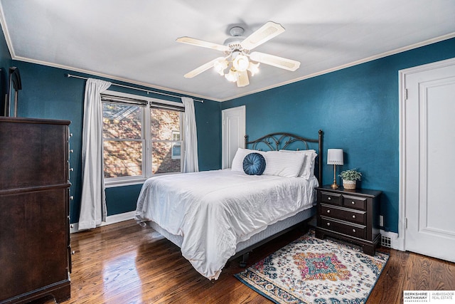 bedroom featuring ceiling fan, crown molding, and dark hardwood / wood-style floors