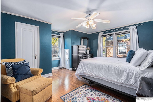 bedroom with ceiling fan, hardwood / wood-style floors, and crown molding