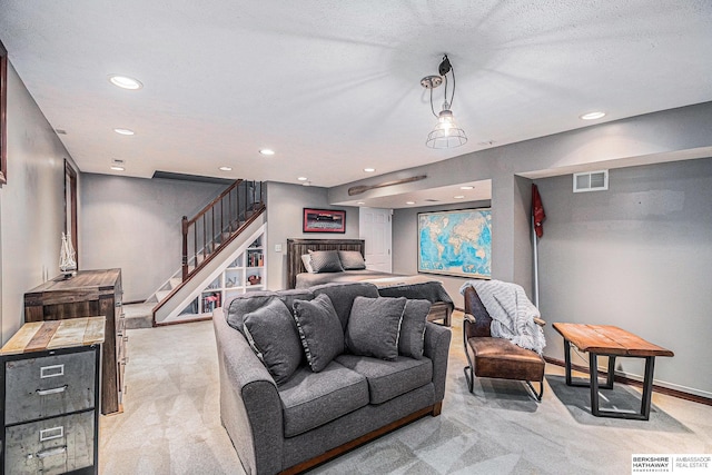 living room featuring light carpet and a textured ceiling