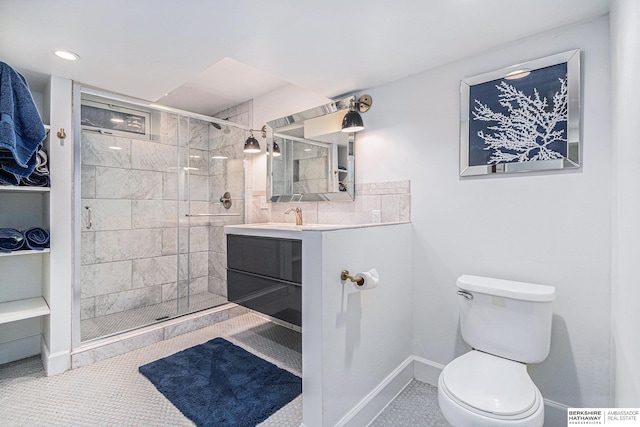 bathroom with tile patterned floors, a shower with door, vanity, and toilet