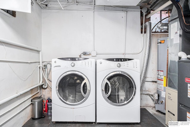 laundry room featuring gas water heater and separate washer and dryer