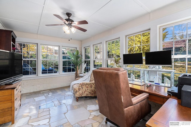 sunroom featuring ceiling fan