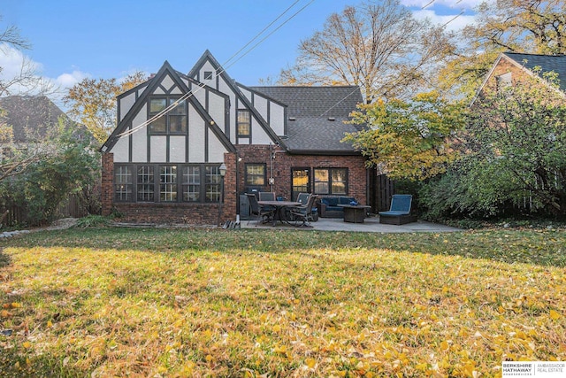 back of property featuring a patio area and a yard