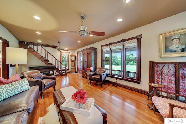 living room with hardwood / wood-style floors and ceiling fan