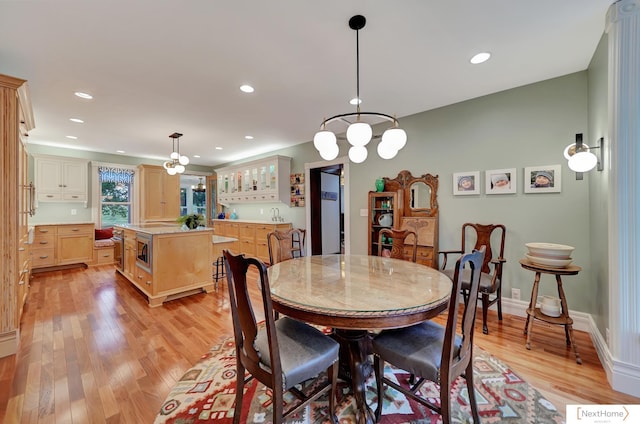 dining area featuring a chandelier and light wood-type flooring