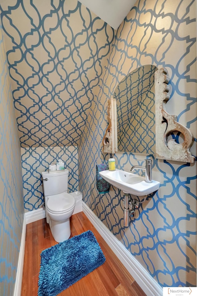 bathroom featuring sink, hardwood / wood-style floors, and toilet