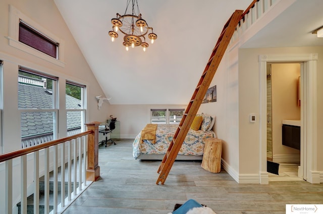 additional living space with a healthy amount of sunlight, light hardwood / wood-style floors, high vaulted ceiling, and an inviting chandelier