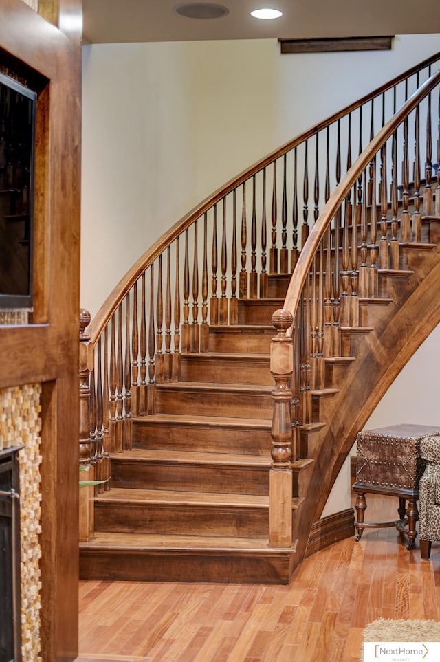 stairs featuring hardwood / wood-style flooring