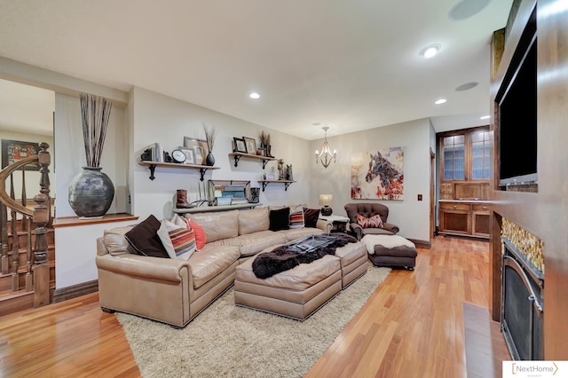 living room with wood-type flooring and an inviting chandelier