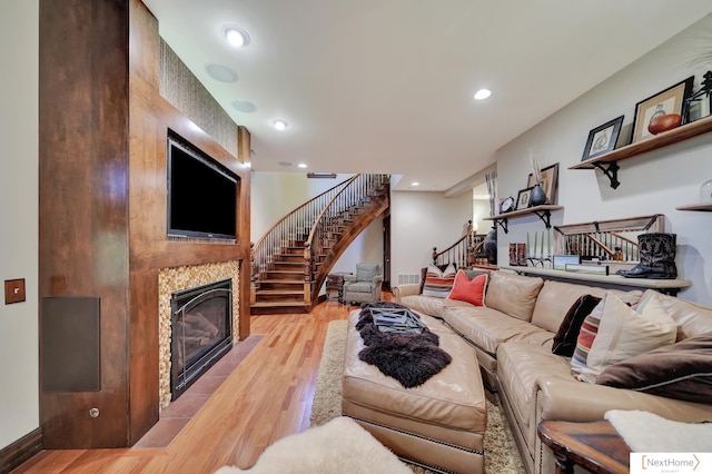 living room with a fireplace and light hardwood / wood-style flooring