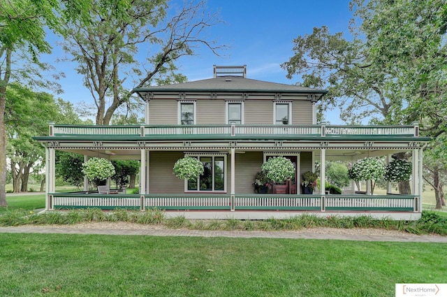 back of house featuring a lawn