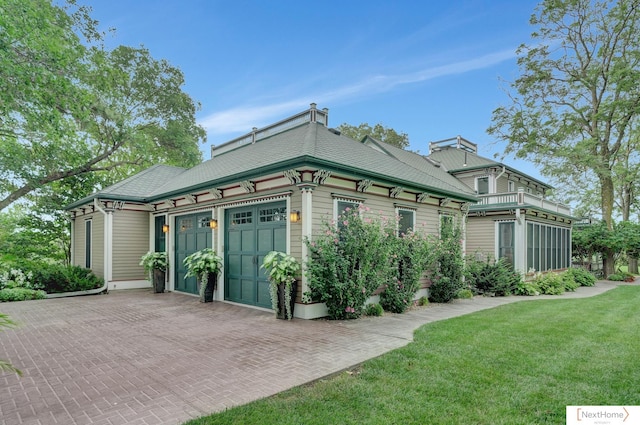 view of property exterior with a yard and a garage