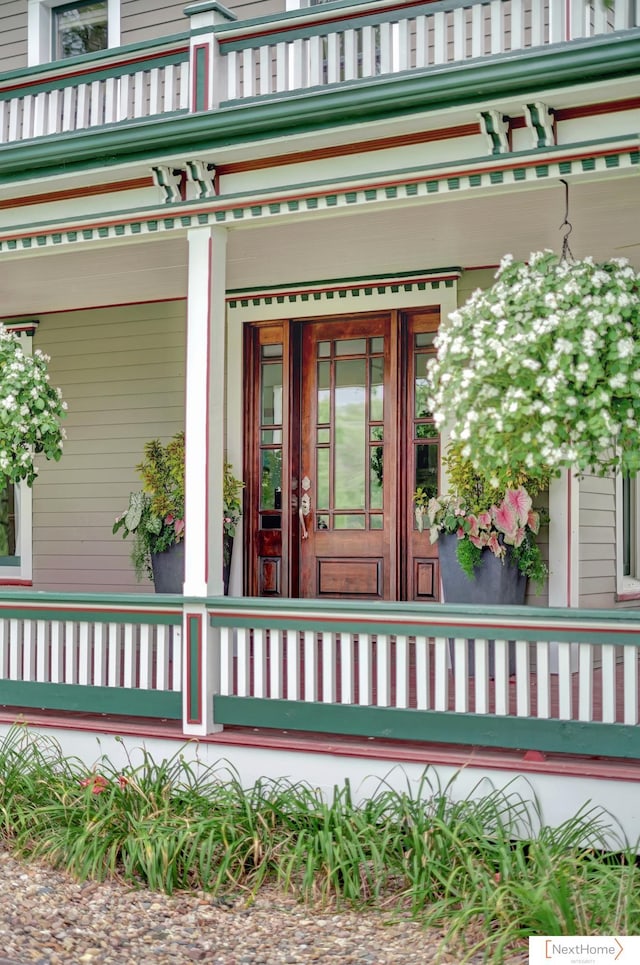 view of exterior entry featuring a porch