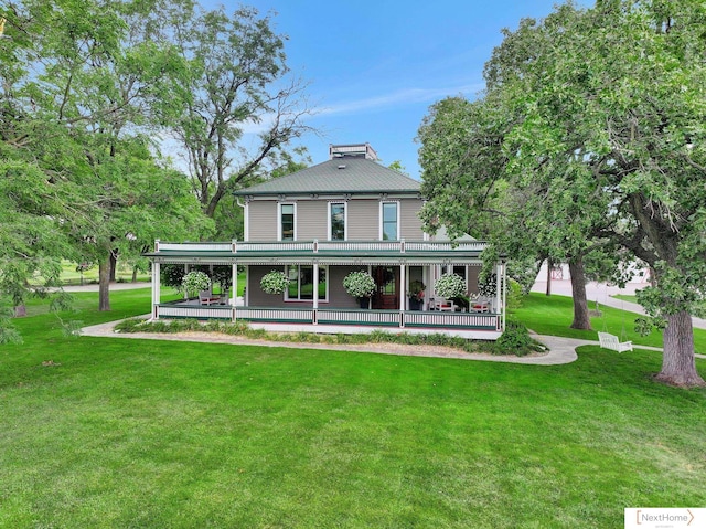 rear view of property with a yard