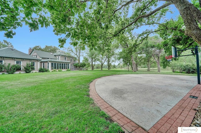 view of yard with basketball hoop