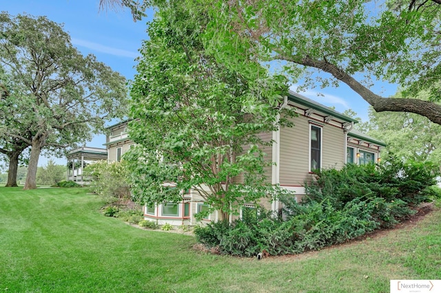 view of side of home featuring a lawn