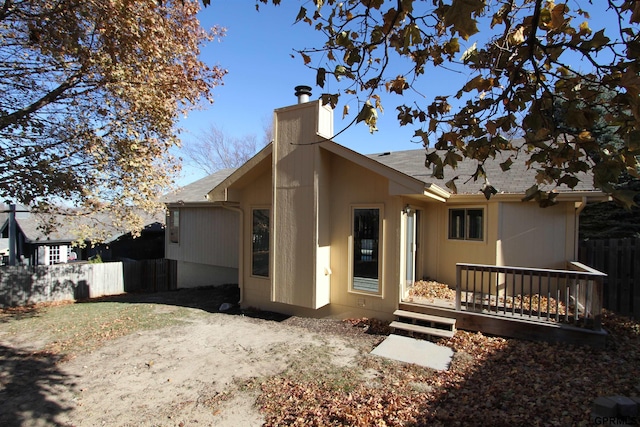 rear view of property featuring a deck