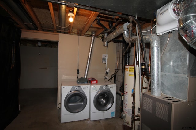 laundry area featuring washer and clothes dryer, heating unit, and water heater