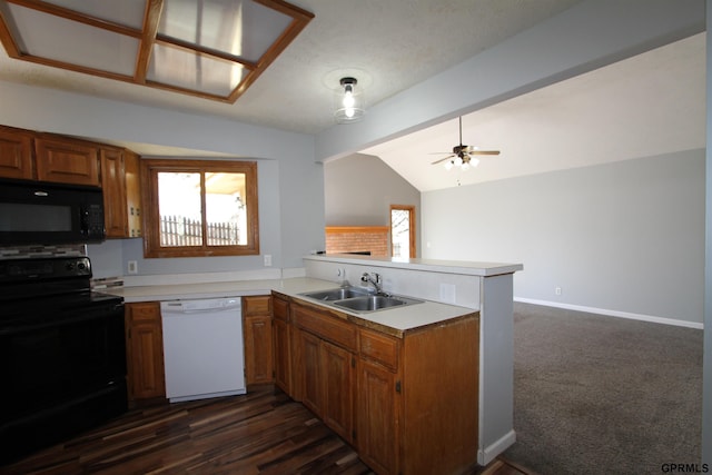 kitchen with kitchen peninsula, vaulted ceiling, sink, black appliances, and dark hardwood / wood-style floors