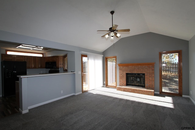 unfurnished living room featuring carpet, vaulted ceiling, plenty of natural light, and ceiling fan