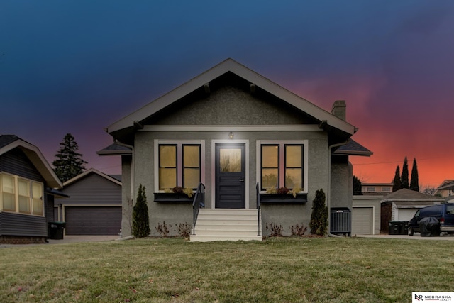 view of front of house with a yard and central AC unit