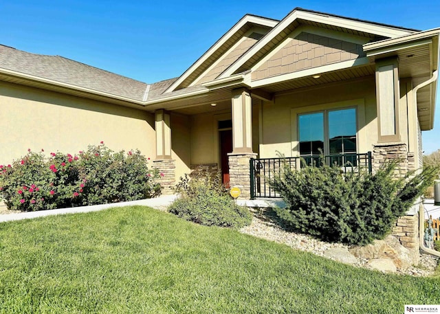 property entrance featuring a lawn and covered porch