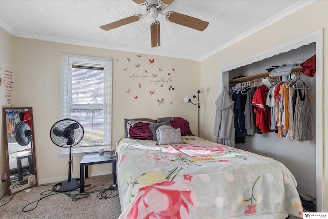 carpeted bedroom with ceiling fan, a closet, a textured ceiling, and ornamental molding