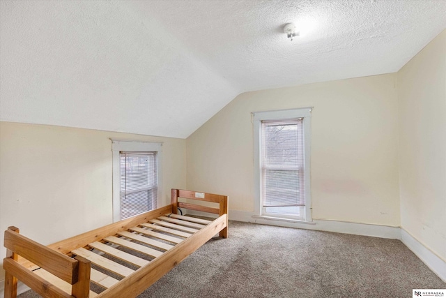 bonus room featuring carpet, a textured ceiling, and vaulted ceiling