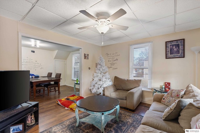 living room featuring a paneled ceiling, dark hardwood / wood-style floors, and ceiling fan