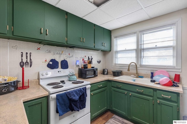 kitchen featuring white range with electric stovetop, green cabinets, and sink