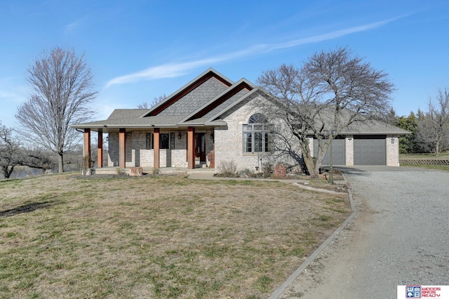 view of front facade with a porch, a garage, and a front lawn