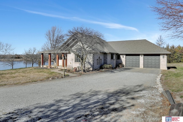 view of front of house with a water view and a garage