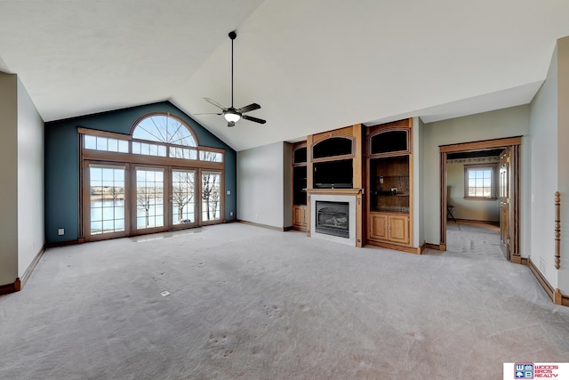 unfurnished living room with ceiling fan, light carpet, and high vaulted ceiling