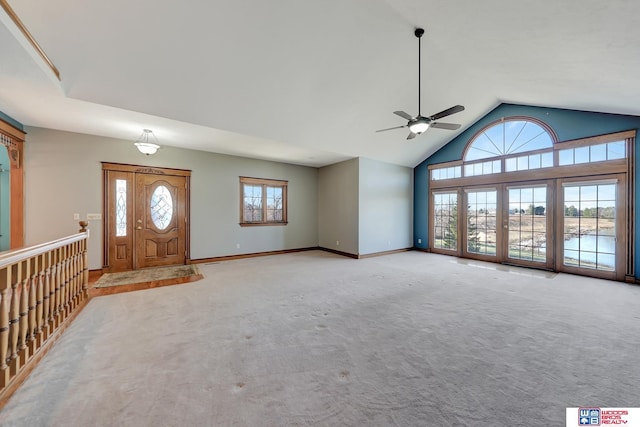 carpeted entrance foyer featuring high vaulted ceiling and ceiling fan