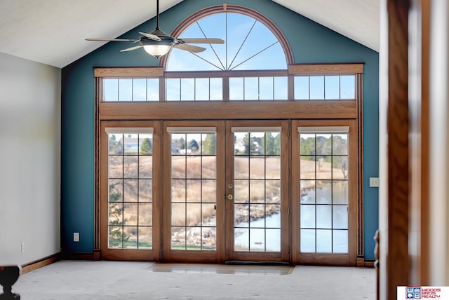 doorway with ceiling fan, a healthy amount of sunlight, and lofted ceiling