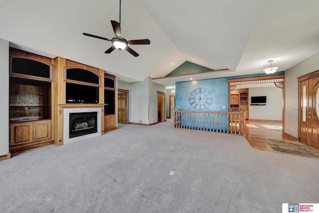 unfurnished living room with ceiling fan, light carpet, and vaulted ceiling