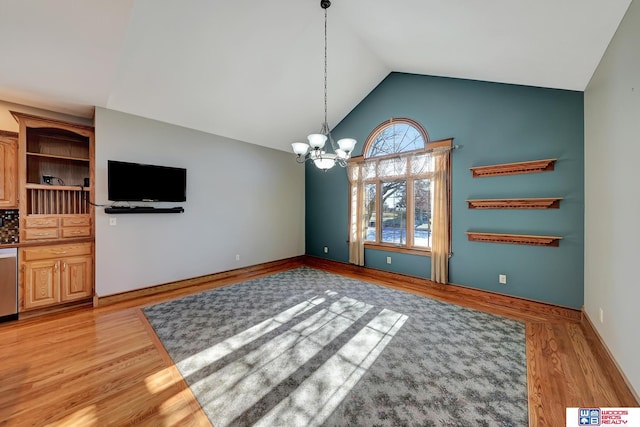 unfurnished dining area with a chandelier, light hardwood / wood-style floors, and lofted ceiling