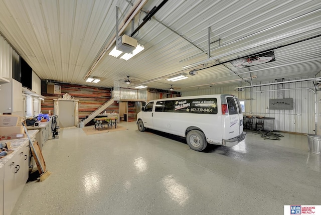 garage with ceiling fan and a garage door opener